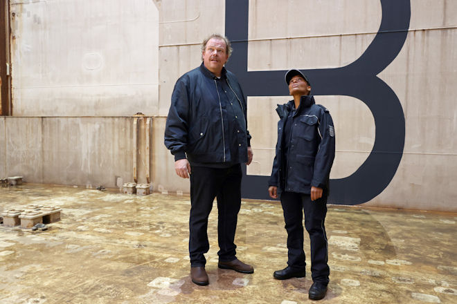 Gero von Bernbeck (Bernd Hölscher, links) und Lisa Cunningham (Cynthia Micas, rechts) durchsuchen den leeren Frachtraum des Containerschiffs "Hundred Waves".